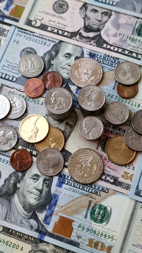 Paper US dollar bills of various denominations and cent coins as a business tool Stock Footage 338012006