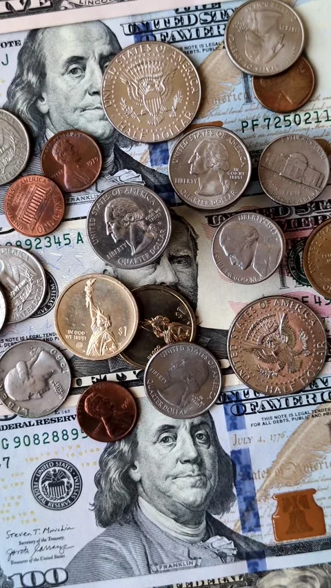 Paper US dollar bills of various denominations and cent coins as a business tool Stock Footage 338012013
