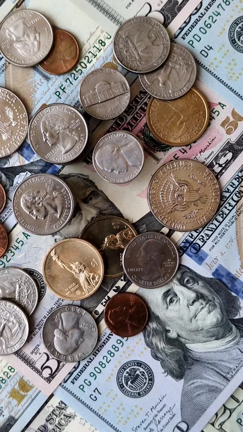 Paper US dollar bills of various denominations and cent coins as a business tool Stock Footage 338012021