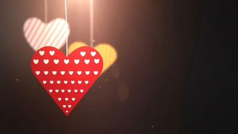 Paper valentine hearts falling down hanging on string black background Stock Footage 96286857