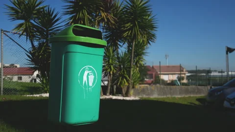 Paper wastes sorting can. Disposing of cardboard garbage. Green color dustbin. Stock Footage 166543072