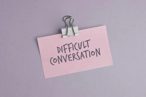 Paper with the word DIFFICULT CONVERSATION on colored background. Difficult.. Stock Photos