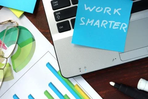 Paper with work smarter on the notebook. Stock Photos
