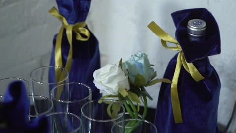 A paper-wrapped bottle of champagne on the table 스톡 동영상 164106784