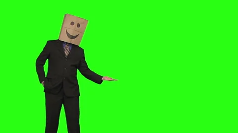 The paperbag man is presenting your text. green background Stock Footage 49863335