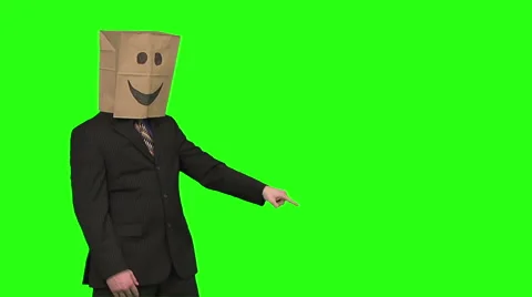 The paperbag man is presenting your text. green background Video stock 49863339