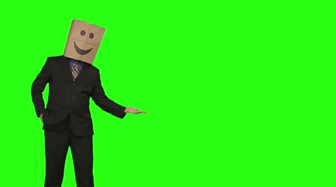 The paperbag man is presenting your text. green background Stock Footage 49863349