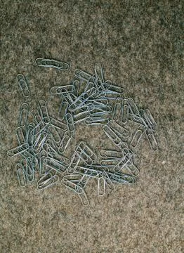 Paperclips on the background of felt Stock Photos