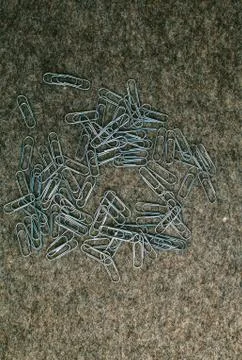 Paperclips on the background of felt Stock Photos