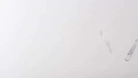 Paperclips fall into shot in slow motion Stock Footage 117349919