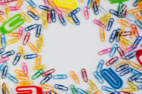Paperclips on the white surface, designed frame shape Stock Photos