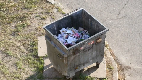  Papers Flies In The Wind From Garbage Can In City  Stock Footage 129077344
