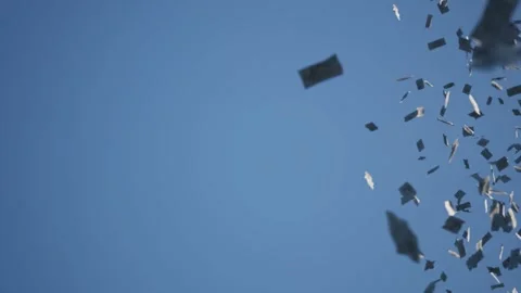 Papers fly across the sky. The wind blows the money notes through the air. Stock Footage 288454273