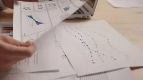 Papers with reports and tables on the table, men point to them 스톡 동영상 191884851