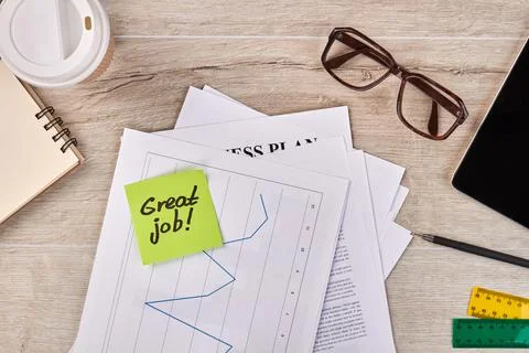 Papers with statistic graph and glasses with notepad. Stockfoto's