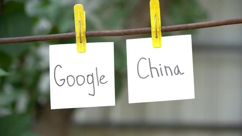 Papers with the words China and Google on yellow clothespins hanging on rod. Stock Footage 108774941