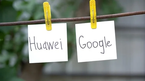 Papers with the words Huawei and Google on yellow clothespins hanging on rod. Stock Footage 108773218