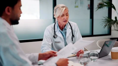 Paperwork, doctors and talking in meeting for healthcare review, treatment Stock Footage 335919511