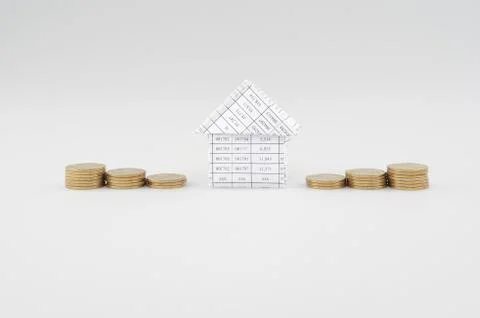 Paperwork as house place between step pile of gold coins Stock Photos