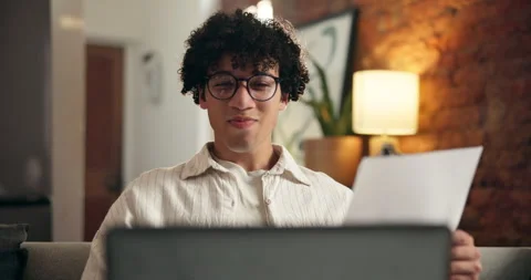 Paperwork, laptop and man with reading for work from home, data entry and update Stock Footage 329391620