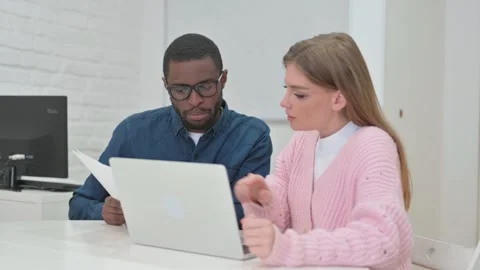 Paperwork on Laptop by Young Teammates Stock Footage 309528870