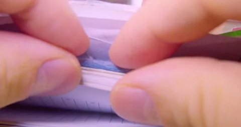 Paperwork in an office. Fingers flipping through a stack of documents Stock Footage 334944590
