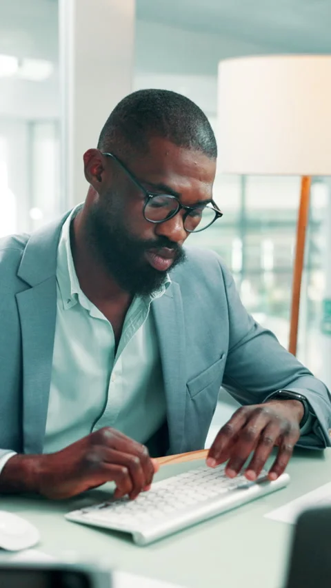 Paperwork, reading or black man typing in office, identify new market trend or Stock Footage 330536116