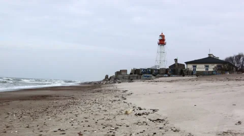 Papes lighthouse on Baltic sea beach. Stock Footage 35504866