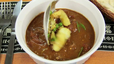 Pappadum Into Beef Curry Stock Footage 1091072