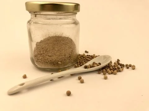 Papper glass jars with papper seed and spoon on isolated white background Stock Photos