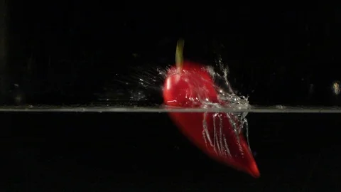 Paprika falling into water in slow motion Stock Footage 88788408