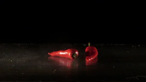 Paprika getting flamed on a wet surface in slow motion Stock Footage 88806095