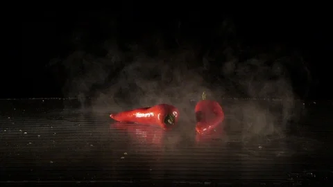 Paprika getting flamed on a wet surface in slow motion Stock Footage 88806175