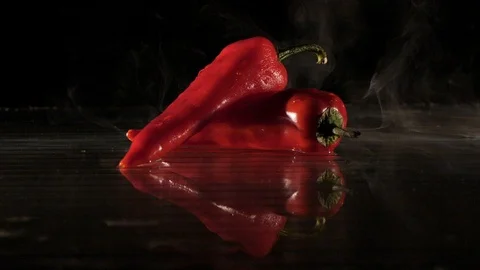 Paprika getting flamed on a wet surface in slow motion Stock Footage 88806348