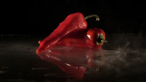 Paprika getting flamed on a wet surface in slow motion Stock Footage 88806539