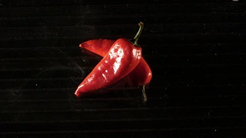 Paprika getting flamed on a wet surface in slow motion Stock Footage 88807219