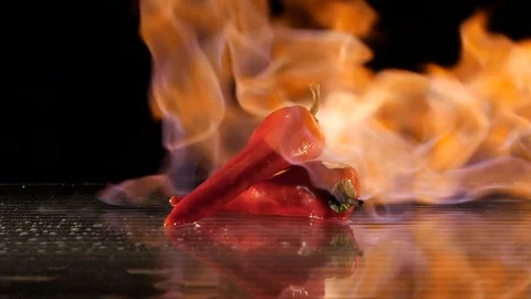 Paprika getting flamed on a wet surface in slow motion Stock Footage 88807345