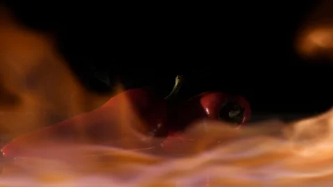 Paprika getting flamed on a wet surface in slow motion Stock Footage 88807506