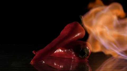 Paprika getting flamed on a wet surface in slow motion Stock Footage 88807599