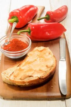 Paprika spread on a slice of bread Stock Photos