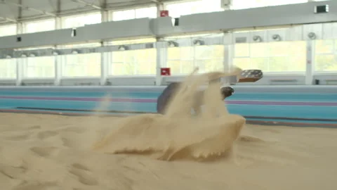 Para-athlete Doing Long Jump on Indoor Track Stockbeeldmateriaal 259284640