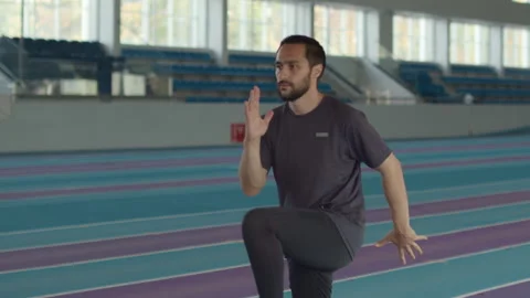Para-athlete with Leg Prosthesis Walking with High Knees on Track Video stock 259288160