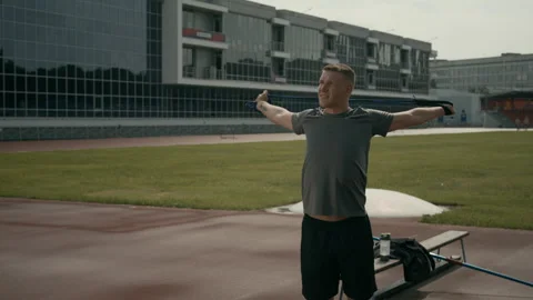 Para-Athlete with Missing Hand Stretching Chest with Elastic at Outdoor Stadium Video stock 297952989