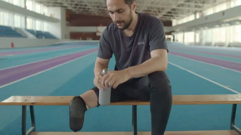 Para-athlete Taking off Running Blade after Indoor Training Video stock 259285434