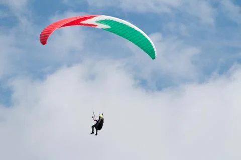 A para-glider up in the sky during a fly, surrounded by the clouds Stock Photos