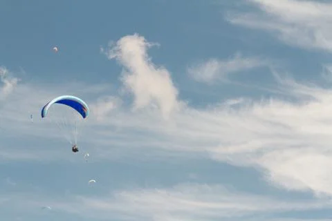 A para-glider up in the sky during a fly, surrounded by the clouds Stock Photos