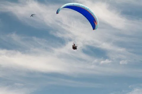 A para-glider up in the sky during a fly, surrounded by the clouds Stock Photos