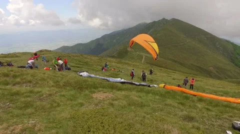 Para glider taking off the mountain Stock Footage