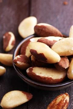 Para nuts on a rustic wooden table and para nuts in bowl. Stock Photos