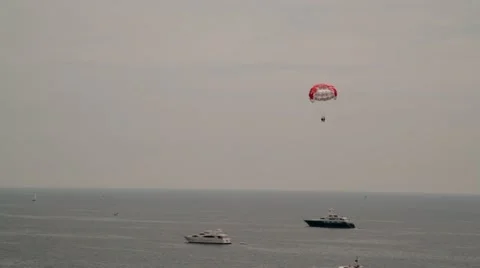 Para-sailing over the sea in front of Cannes Stock Footage 15470121